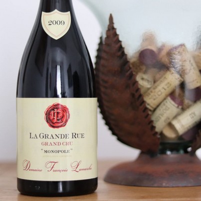 Elite selection of 6 Burgundy Grand Cru wine bottles, including Montrachet and La Grande Rue Monopole for a luxury wine tasting class in Beaune.